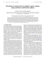 Wavefront reconstruction in adaptive optics systems using nonlinear multivariate splines